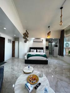 a bedroom with a bed and a table with food on it at Red Sea Studio Partial Sea View استديو بحر الأحمر اطلالة جزئية in Jeddah