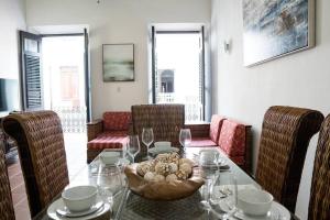 a dining room with a glass table and chairs at Historic Apt w/ 3BR Near La Fortaleza OSJ in San Juan