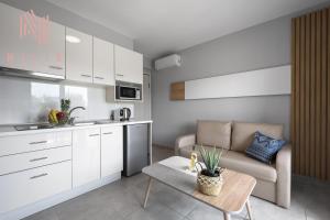 a kitchen and living room with a couch and a table at Ouranos, Nilie Hospitality MGMT in Nikiti +43 photos