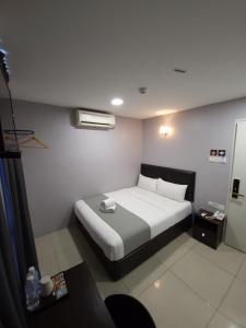 a bedroom with a large white bed in a room at Royale City Hotel - 10 min from KLIA KLIA 2 Airport in Sepang
