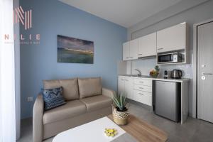 a living room with a couch and a kitchen at Ouranos, Nilie Hospitality MGMT in Nikiti