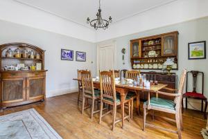 a dining room with a wooden table and chairs at Roscrea Bed & Breakfast in Bodmin