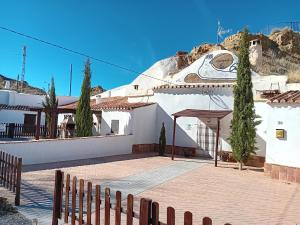 a white building with a mural on the side of it at Cueva La Ermita II in Guadix