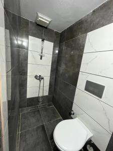 a bathroom with a toilet and a shower at Erkal Pension in Antalya