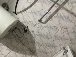 a white marble shower wall in a bathroom at Best Yessit Homestay in Abuja +15 photos