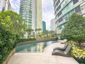 a swimming pool in a city with tall buildings at Avant Spacious Sanctuary with the best view in BGC in Manila