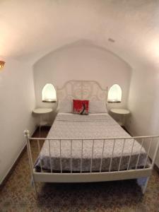 a bedroom with a bed with two night stands at Cueva La Ermita II in Guadix