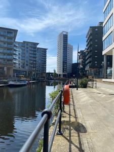 a body of water with buildings in the background at Leeds Dock Apartment in Leeds