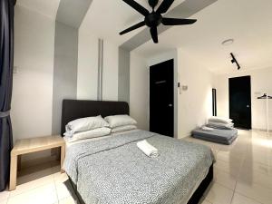 a bedroom with a bed with a ceiling fan at BNB Cozy Homestay @ Cyberjaya in Cyberjaya +30 photos