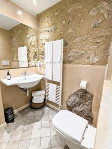 a bathroom with a toilet and a sink at Casal del pigno in Peschiera del Garda