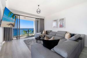 a living room with a couch and a view of the ocean at 3 Bedroom Apartment with Ocean Views in Central Location - Chevron Renaissance - Wow Stay in Gold Coast