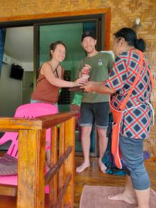 a group of people standing in a room at Kohmook Happy time Bungalow in Koh Mook