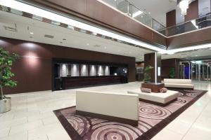a lobby with a couch and a table in a building at Palace Hotel Omiya in Saitama