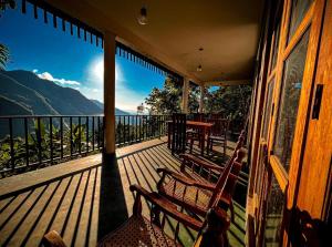 a porch with two chairs and a view of the mountains at Nature Green Hotels On Rock Home Ella in Ella