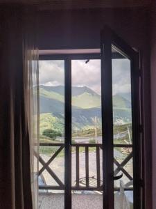 a window with a view of a mountain view at Khando2023 in Gudauri