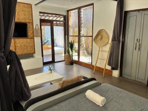 a living room with a couch and a table at Villa Maiya in Gili Islands