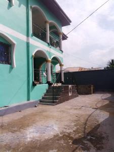 a blue building with stairs and a balcony at NGOME Lounge 