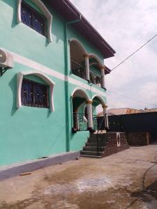 a blue building with stairs and balconies on it at NGOME Lounge 