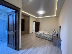 a bedroom with a bed in a room with wooden floors at Modern living in Addis Ababa