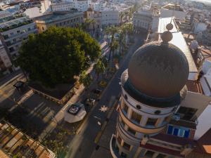 an aerial view of a city with a building at Conjunto de APARTAMENTOS ANTIGUO PALACIO HOTEL PARIS in Huelva