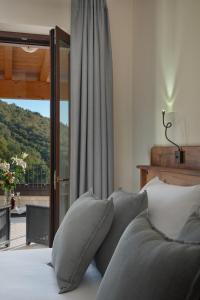 a bed with pillows in a bedroom with a window at Sporting Hotel San Felice in Illasi