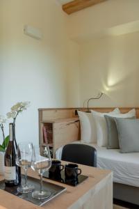 a bedroom with a bed and a table with wine glasses at Sporting Hotel San Felice in Illasi