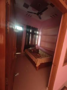 a small room with a bed and a ceiling at Divine INN hotel and guest house in Bamrauli