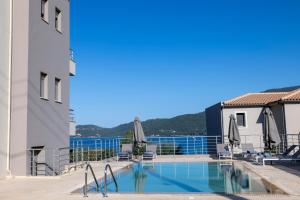 a swimming pool on the roof of a building at Malena in Karavomylos