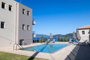 a large swimming pool next to a building at Malena in Karavomylos