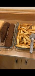 a table with a tray of hot dogs and french fries at Red White Hotel in Istanbul