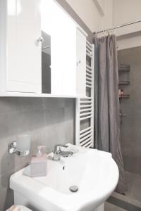 a bathroom with a white sink and a mirror at Cozy Cityscape Apartment in Athens in Athens