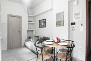 a living room with a table and a couch at Cozy Cityscape Apartment in Athens in Athens