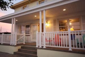 a house with a porch with a white railing at Clarem Happy Days in Wildwood