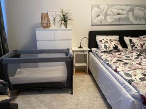 a bedroom with a bed and a dresser at Peaceful City Centre Apartment (2 Bdr) in Rovaniemi