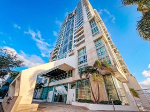 a tall building with palm trees in front of it at Luxurious SubPh Apt Atlantis W/ Ocean View & PRK in San Juan