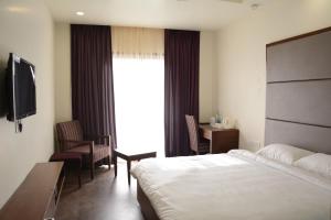 Säng eller sängar i ett rum på Green Hotel & Restaurant