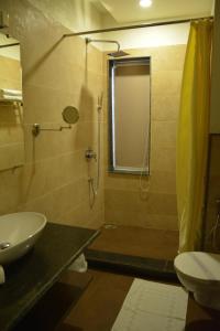 y baño con ducha, lavabo y aseo. en Green Hotel & Restaurant, en Pathankot