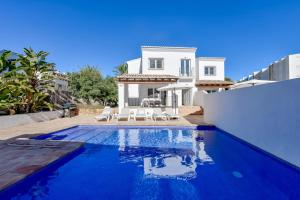 a villa with a swimming pool in front of a house at Bianca - by Almarina Villas in Teulada