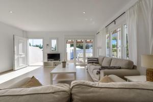 a living room with a couch and a table at Bianca - by Almarina Villas in Teulada