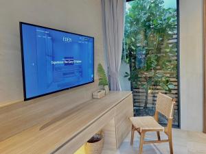 a living room with a large flat screen tv at Eden Resort & Villas in Patong Beach