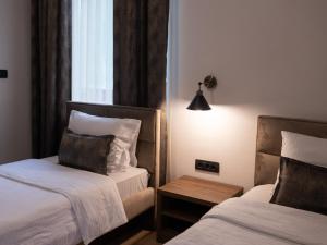 Postel nebo postele na pokoji v ubytování Hotel RAS Pazarište