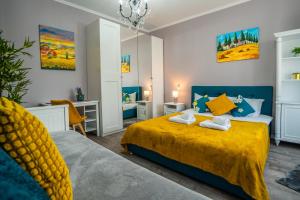 a bedroom with two beds and a yellow bedspread at Chic Studio Old City Center - IVO19 in Bucharest +83 photos