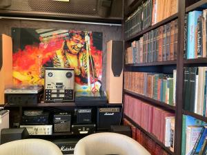a book shelf with a large screen in a library at Marbella Boutique Art suites in Marbella
