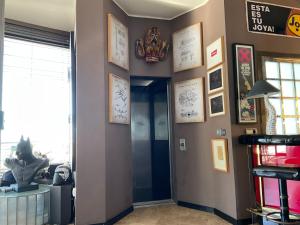 a hallway with pictures on the walls of a room at Marbella Boutique Art suites in Marbella