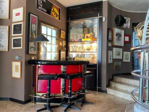 a bar with two stools and a red counter at Marbella Boutique Art suites in Marbella