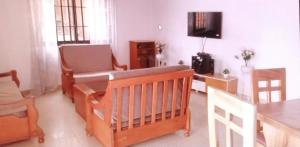 - un salon avec un lit bébé, une table et une télévision dans l'établissement Guest house In benin, à Abomey-Calavi