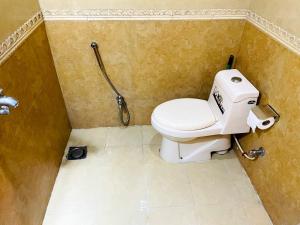 a bathroom with a toilet and a shower at Infinity Hotel in Lahore