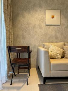 a living room with a couch and a side table at TATA Rio de Goa ,Good Stay Premium 2 BHK Apartment,6 km from Airport, - 101 in Dabolim