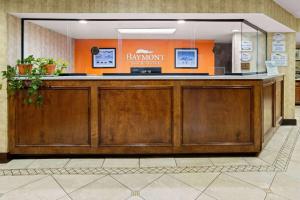 a bar in a lobby with an orange wall at Baymont by Wyndham Griffin in Griffin +63 photos
