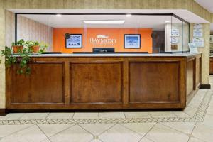 a bar in a lobby with an orange wall at Baymont by Wyndham Griffin in Griffin